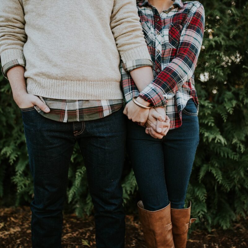 woman holding man hand